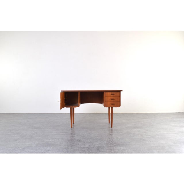 This teak desk was manufactured in Denmark in the 1960s and exemplifies the Mid-Century Modern style, which emphasized...