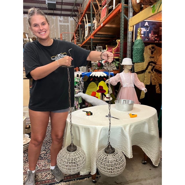 Up for consideration is a beautiful vintage pair of round Hollywood regency crystal and bronze pendant chandeliers. These...