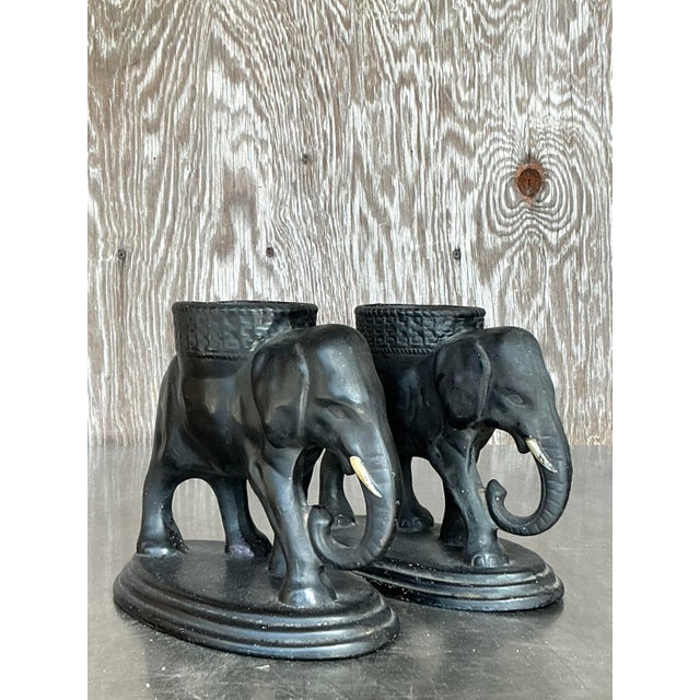 Add a touch of exotic charm to your decor with this unique set of two vintage boho-style ceramic elephant sculptures....