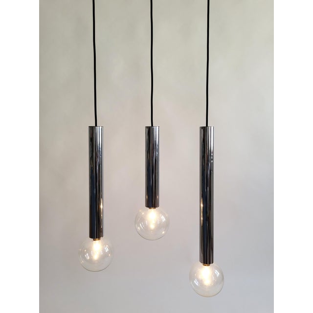 Set of three Space Age STAFF pendant lights, designed by Motoko Ishii in the 1970s, forming a cascade. Each set consists...