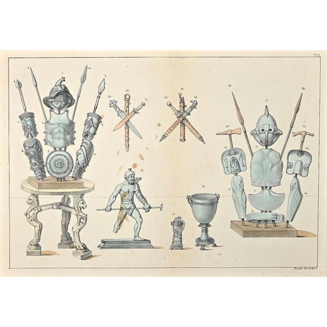 Equipment for gladiators is an original hand-colored lithograph on paper realized by an Italian anonymous artist of the...