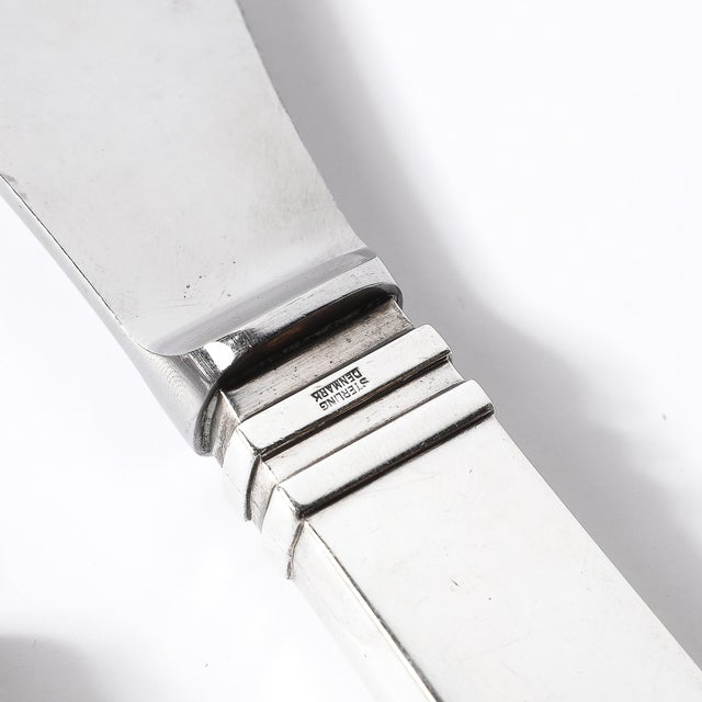 This Art Deco carving set by renowned Danish silversmith Georg Jensen, crafted circa 1930, is a masterpiece of Skyscraper-...