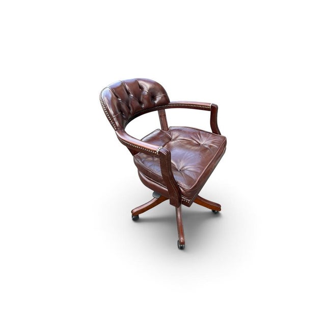 English Chesterfield style - Vintage swivel office chair with a brown leather seat, nailhead trim, on castors wheels.