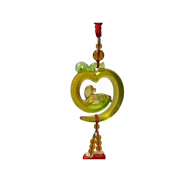 This is a liuli crystal glass art piece in a Chinese Fengshui green apple shape with pixiu pendant. It is made into a...