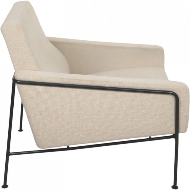 Arne Jacobsen 3301 Airport chair upholstered in beige fabric and with a black frame. The chair was reupholstered around 20...