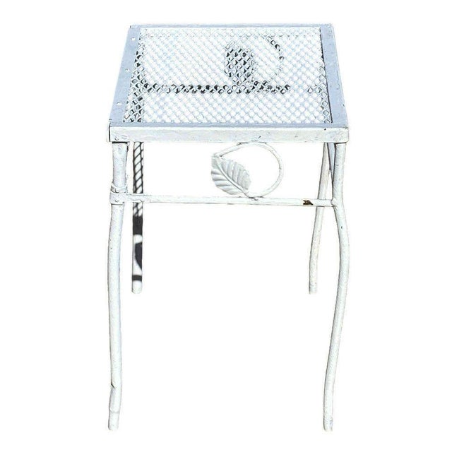 Mid-century wrought iron and steel mesh low side table for patio and outdoor use. The side table features a trellis...