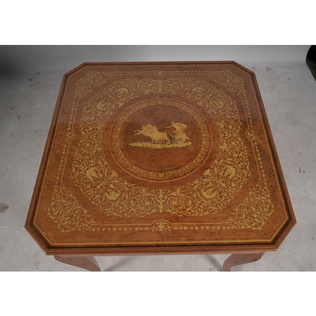 A wonderfully elaborate vintage Italian convertible game table featuring extensive marquetry decoration and multiple...