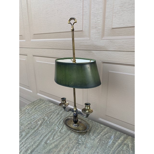A gorgeous brass bouillotte lamp with reticulated base and green paper shade USA, Mid-20th Century Measures: 10"W x 6.5"D...