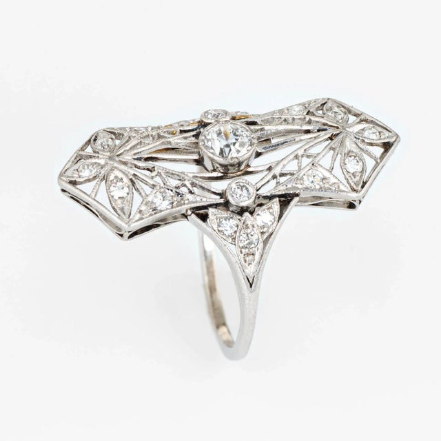 Finely detailed antique Edwardian ring (circa 1900s to 1910s) crafted in 900 platinum. Centrally mounted estimated 0.25...