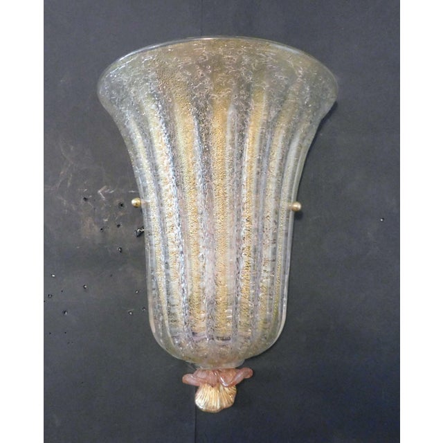 Italian wall light with a Murano glass shield hand blown with granular texture and infused with gold flecks including a...