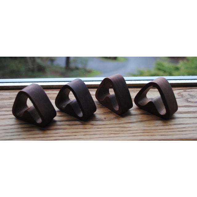 Set of 4 Mid Century Teak Napkin Rings. Most likely made in the Phillip the 1960's. Triangular, with a V shaped middle to...