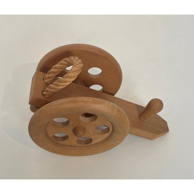 This beautiful and unusual cannon bottle holder is made of wood and rope. It is a French work by Adrien Audoux and Frida...