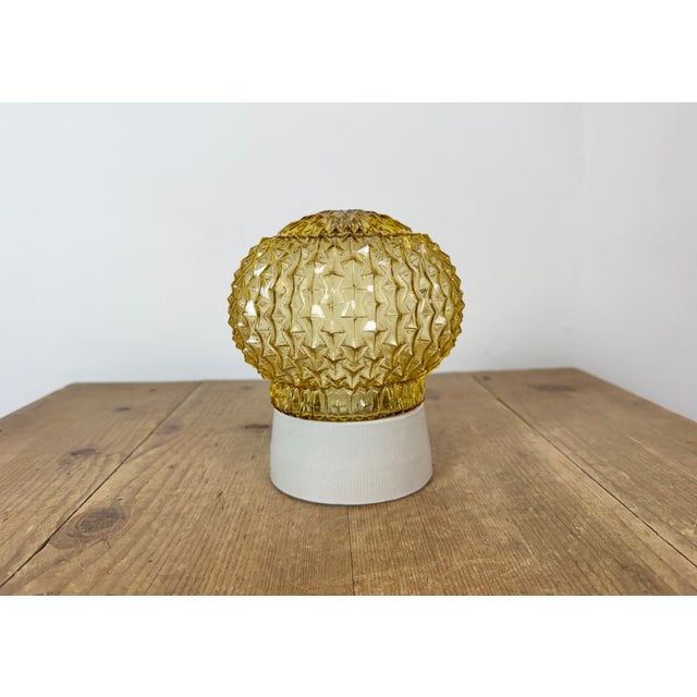 Vintage industrial ceiling or wall light made in former Czechoslovakia during the 1970s. It features a white porcelain...