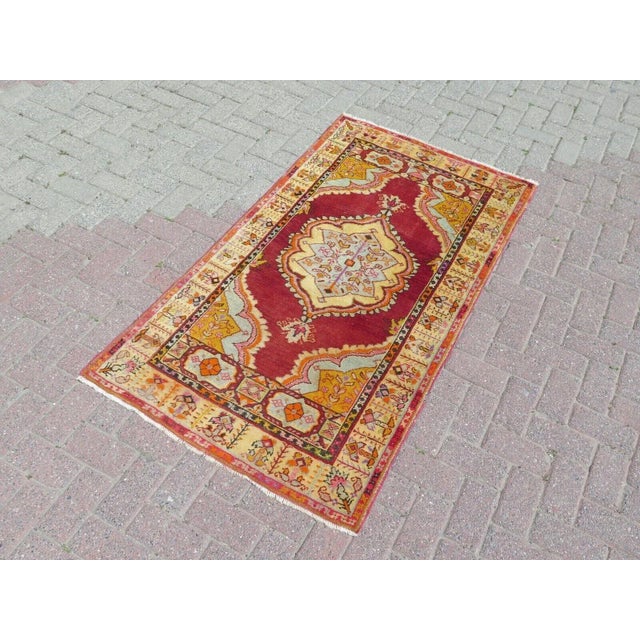 This beautiful, traditional vintage, handknotted Turkish rug is approximately 60 years old. It is handmade of very fine...