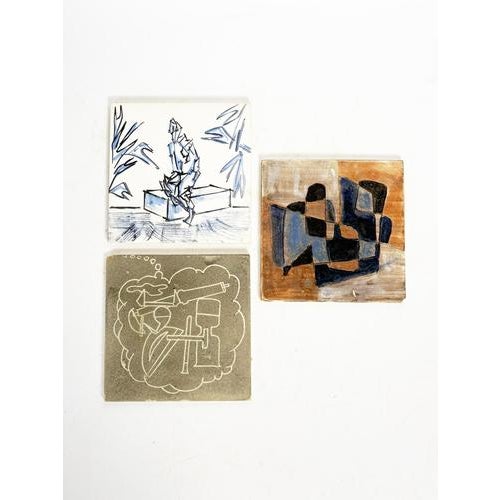 Set of three decorative ceramic coasters dating from the 1960s. Each piece features a different illustration in an...