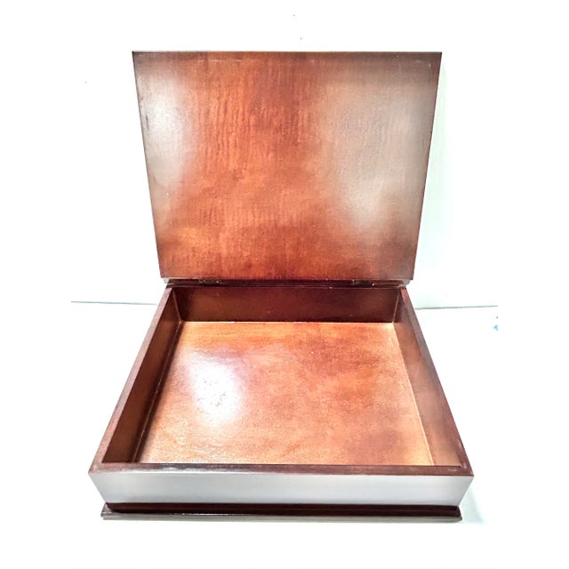 Interior view of an open keepsake box with a square base.