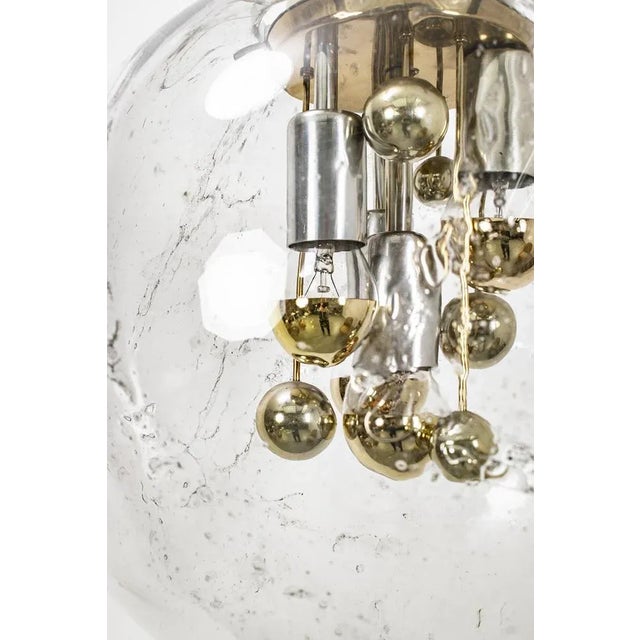 A spectacular, glass, ceiling light by doria with 4 luminous points. There are some minor scratches on the aluminum holder...