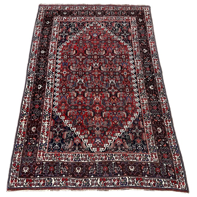 A lovely antique Qashqai rug, handwoven by the eponymous nomadic tribe circa 1910. The rug features an allover design on a...