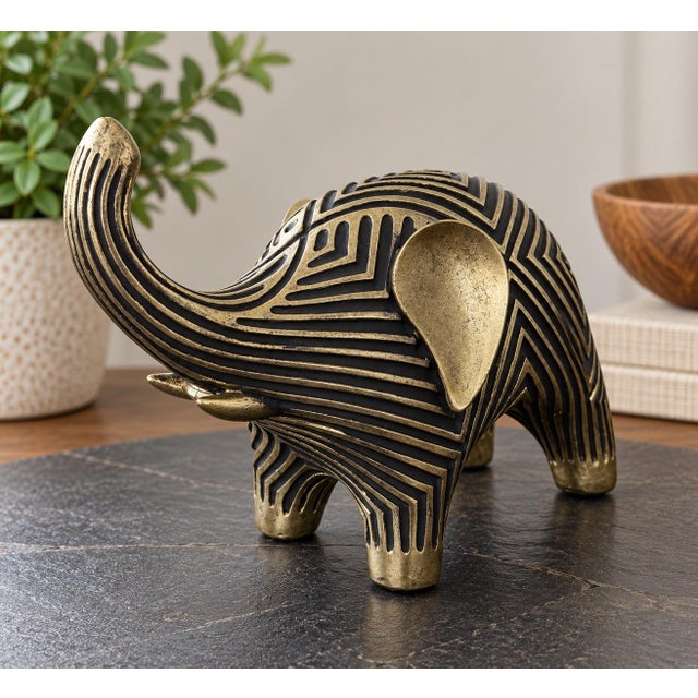 Striking vintage wood elephant sculpture featuring an unusual geometric carved design with contrasting dark recessed lines...