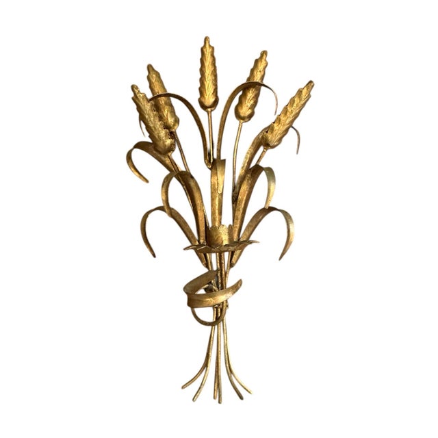 A lovely pair of tole candle sconces. Each features a sculptural wheat form with a single floral form candle cup. Hand...