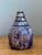 This striking artisanal lidded jar is a testament to the expressive nature of late 20th-century studio pottery. The vessel...