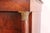 Antique classicist chest of drawers made of solid oak, refined with mahogany veneer, which is mirror-folded into patterns....