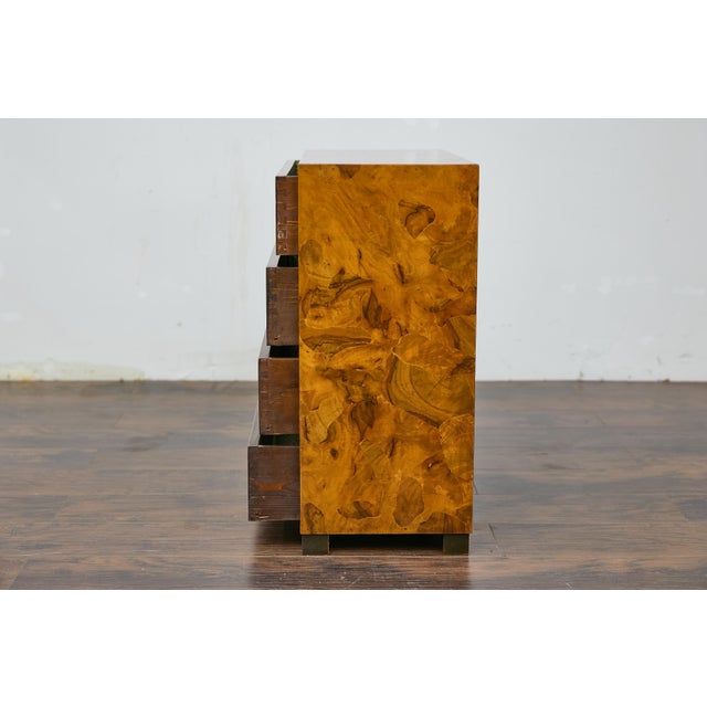 An Italian walnut veneer commode from circa 1940 with four drawers and linear brass inset hardware. This Italian walnut...