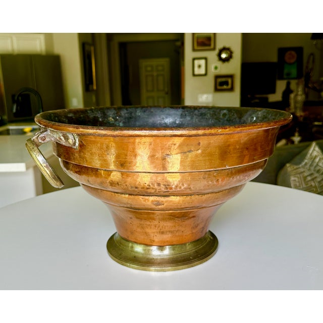 French 1920s footed planter or champagne cooler features a hand-hammered copper body accented with stepped ridges and...