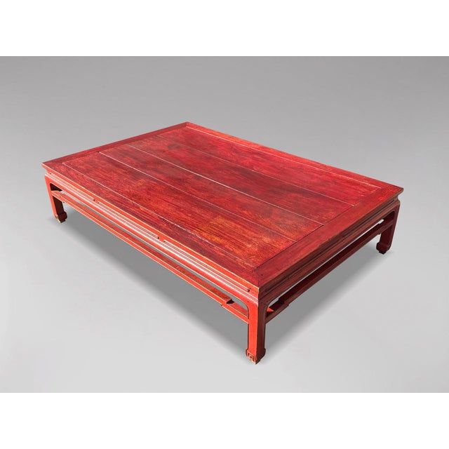 This early 19th-century red lacquered Chinese bed or coffee table dates back to the 1800s. The red lacquer exhibits a soft...