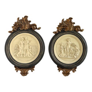 Mid 20th Century Pair of Neoclassical Figural Relief Wall Sculptures in Antiqued Gilt and Black Frames For Sale