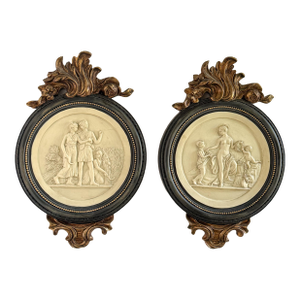 Mid 20th Century Pair of Neoclassical Figural Relief Wall Sculptures in Antiqued Gilt and Black Frames