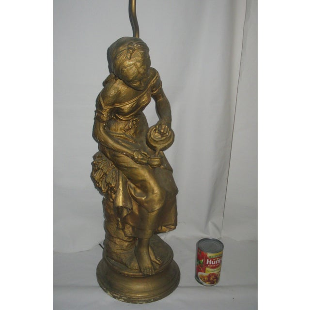 This lamp is made of composition and was produced between 1910 and 1930. It is most likely the work of French sculptor...