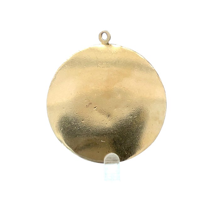 Beautifully crafted round pendant in solid 14K yellow gold, showcasing a detailed Buddha figure holding a polished natural...
