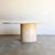 An elegant vintage Italian dining table crafted from solid travertine, featuring a beautifully proportioned oval top...