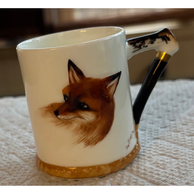 A charming pair of cups and matching saucers from Royal Doulton’s iconic “Reynard the Fox” pattern, made for G. B. & Sons...