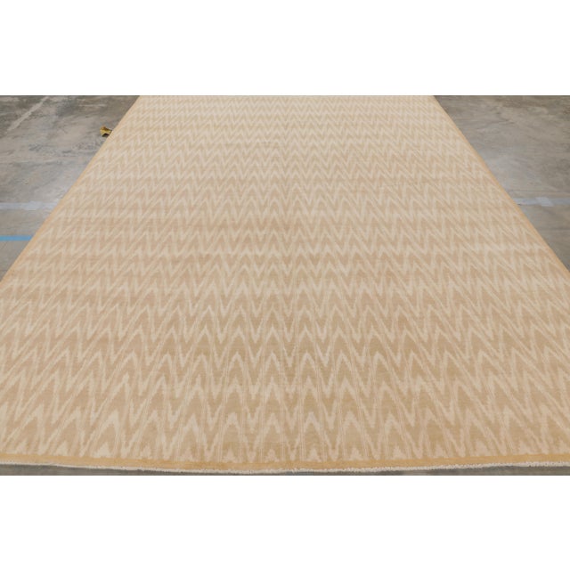 Made with hand-knotted cotton, this 9x12 contemporary rug features a simple repeat of geometric patterns in rows almost...