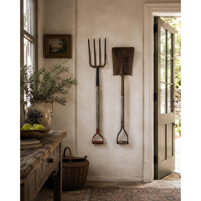 A wonderfully sculptural pair of early 20th century and iron garden implements, comprised of a hay fork and a shovel,...