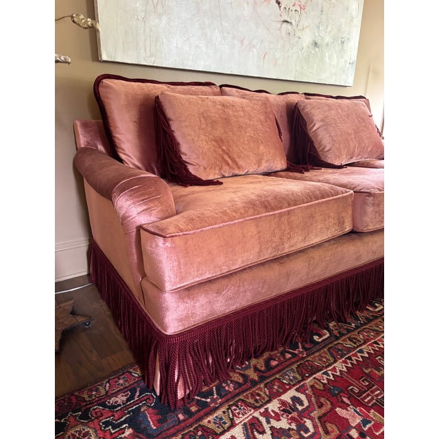 This gorgeous sofa is a showstopper in soft, plush dusty rose velvet upholstery. The rich texture catches the light...