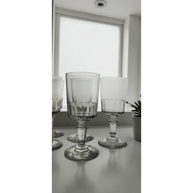 Six Mirabeau pattern water/wine glasses, late 19th/early 20th century. Faceted cut. Height 15.5 cm. Brimmed diameter 7 cm....