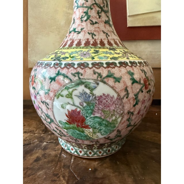 This beautifully hand-painted Chinese famille rose porcelain vase dates to the mid-20th century, circa 1940–1960....