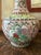 This beautifully hand-painted Chinese famille rose porcelain vase dates to the mid-20th century, circa 1940–1960....