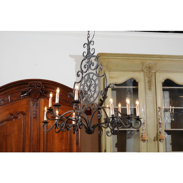 Early 20th Century French 12-Light Wrought-Iron Chandelier with Clock Motif and Scrolling Armature For Sale - Image 4 of 12