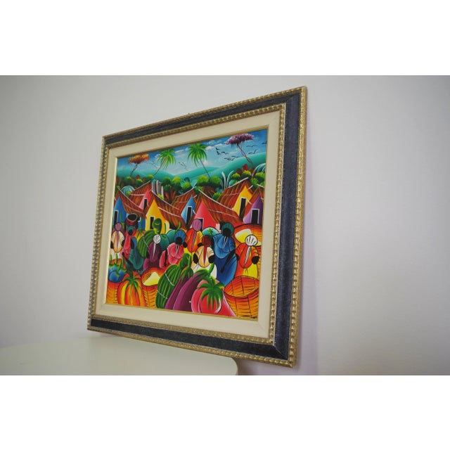 Caribbean painting with carved frame in gold and black, 2000s.