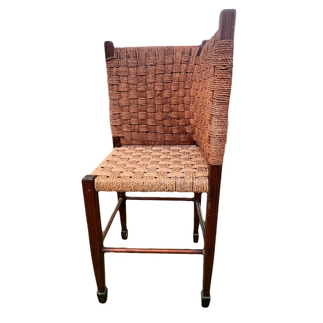 An exceedingly rare form/one-of-a-kind hand made corner chair with woven rope seat and back and channel-carved tapered...