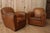 Beautiful pair of cognac-colored leather club chairs. They have a lovely patina, giving them a charming touch of...