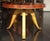 Coffee table with linear grained rosewood veneer top. Raised on three curved legs of fruitwood. Gold Leaf detailing on...
