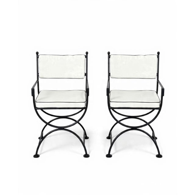 This striking pair of vintage-inspired armchairs offers a masterclass in architectural silhouette and enduring...