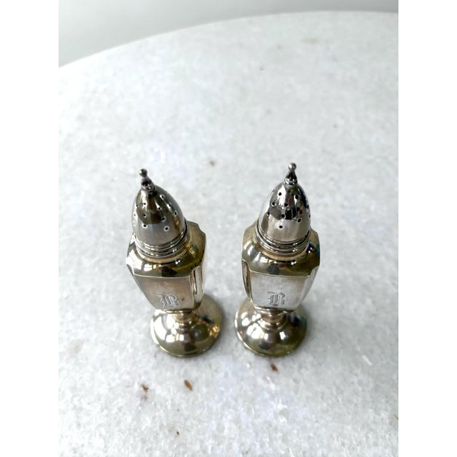Antique sterling silver salt and pepper shakers featuring a monogrammed. Possibly letter B.