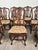 A set of eight Italian fruitwood provincial dining chairs, circa 1920. The side chairs measure 41.75" h 20" seat (with...