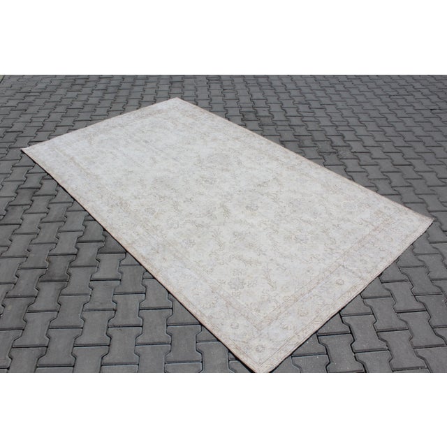 This beautiful, traditional vintage, hand knotted Turkish area rug is approximately 60 years old. It is handmade of very...